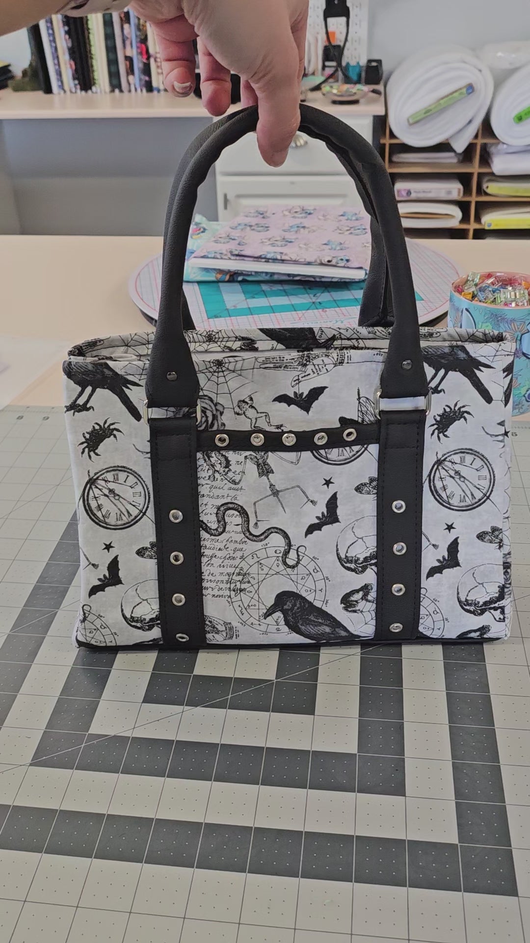 Video of black magic top handle trapeze purse.