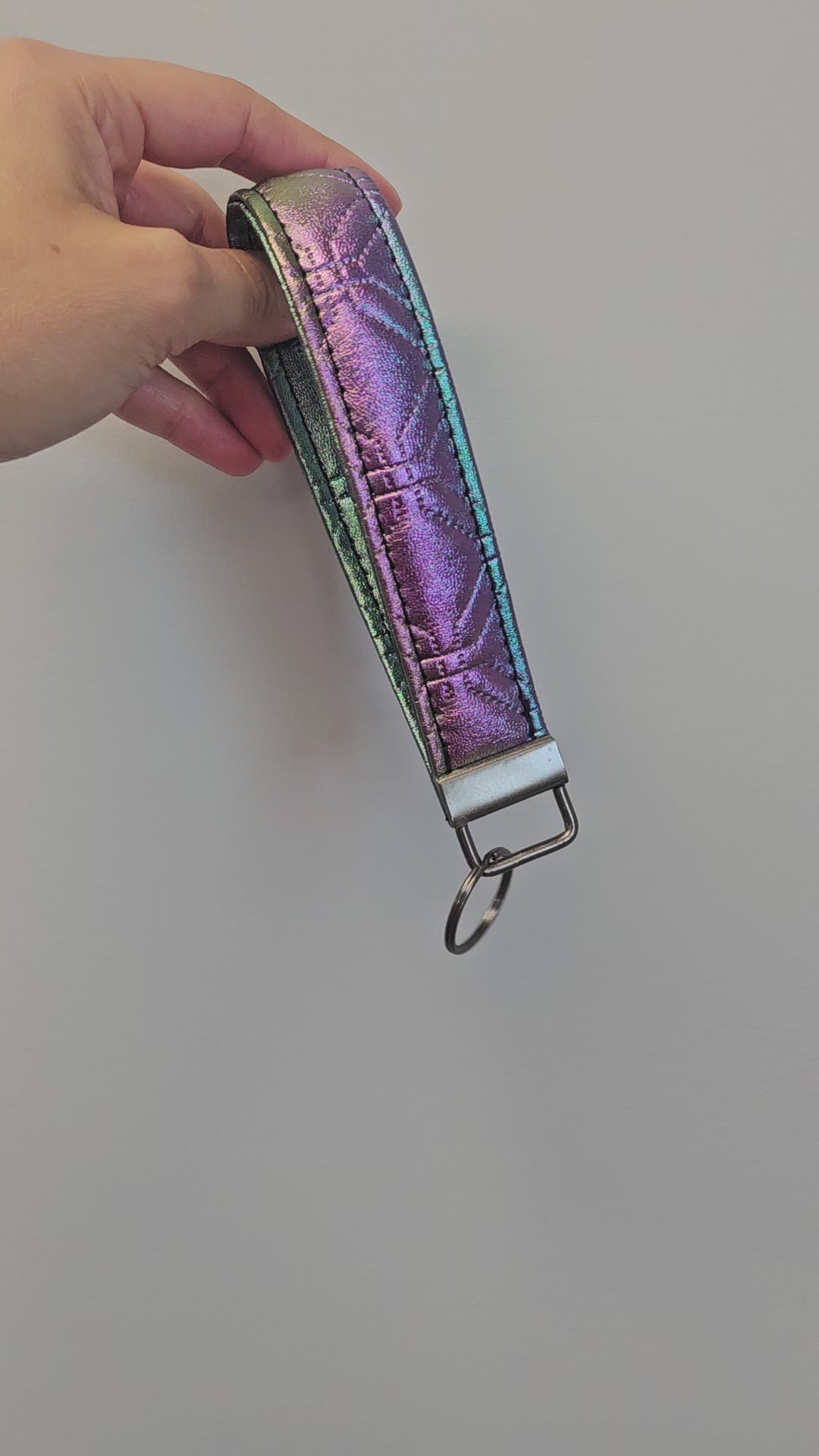 Short video of rainbow metallic faux leather quilted key fob.