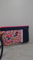 Load and play video in Gallery viewer, Video of the We rise by lifting others zippy clutch.
