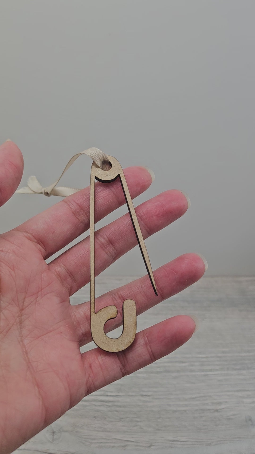 Video of laser cut safety pin ornament blank.