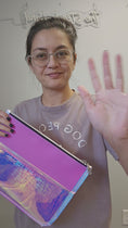 Load and play video in Gallery viewer, Video of the transparent holographic pink large flat zipper pouch.
