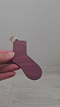 Load and play video in Gallery viewer, Video of sock ornament blank laser cut from exotic purpleheart wood.
