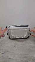 Load and play video in Gallery viewer, Video of the black and white jelly vinyl carry all bag.
