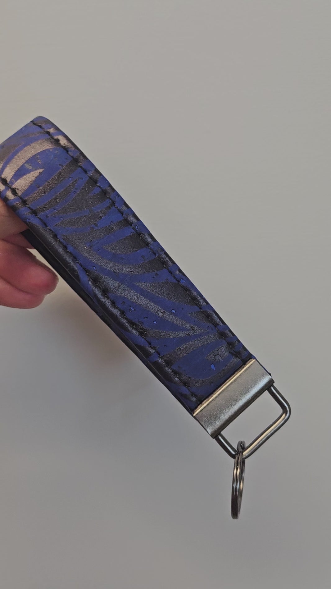 Short video of a blue and black cork key fob.