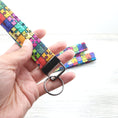 Load image into Gallery viewer, Rainbow puzzle pieces key fob with gunmetal hardware.

