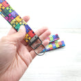Load image into Gallery viewer, Rainbow puzzle pieces wristlet strap.
