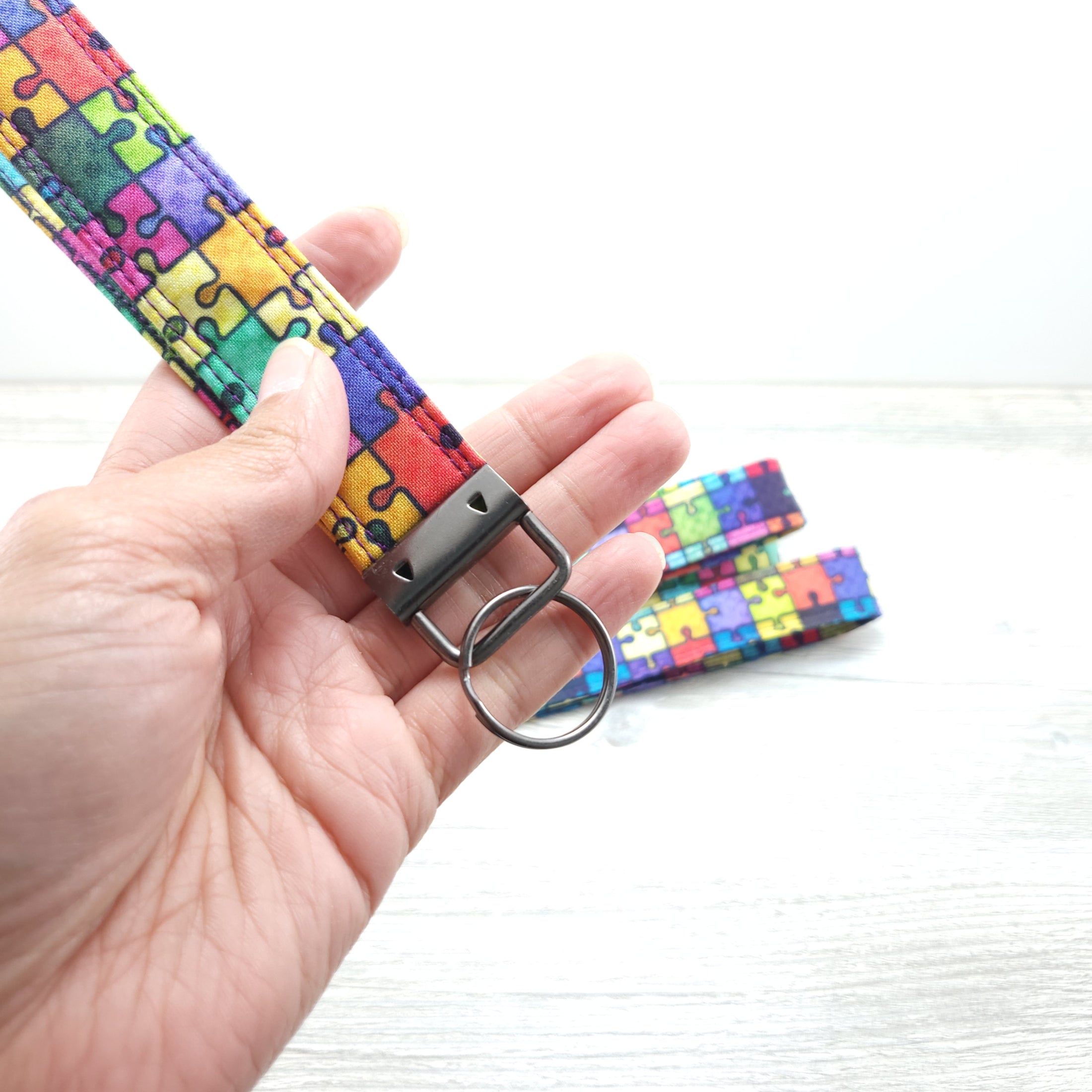 Rainbow puzzle pieces wristlet strap.