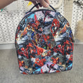 Load image into Gallery viewer, Hand holding up a spiderman backpack. 
