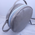 Load image into Gallery viewer, Top front of round vegan leather purse. 
