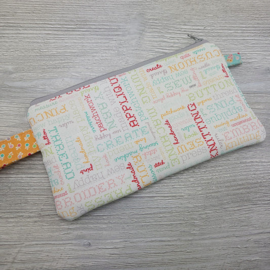 Quilted zipper pouch with handle. 