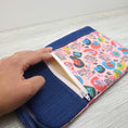 Load image into Gallery viewer, We rise by lifting others wristlet wallet. 
