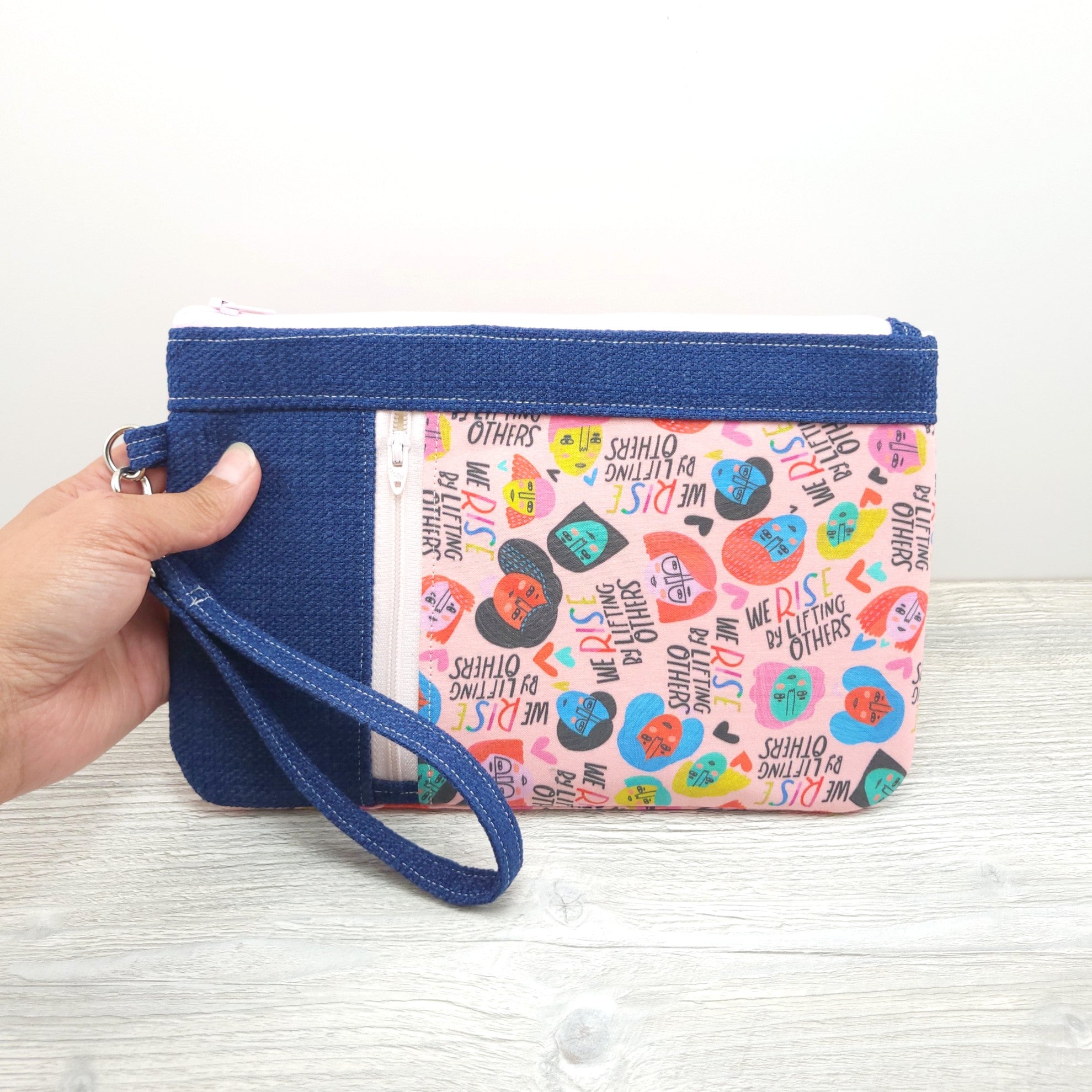 Wristlet with zipper and handle.
